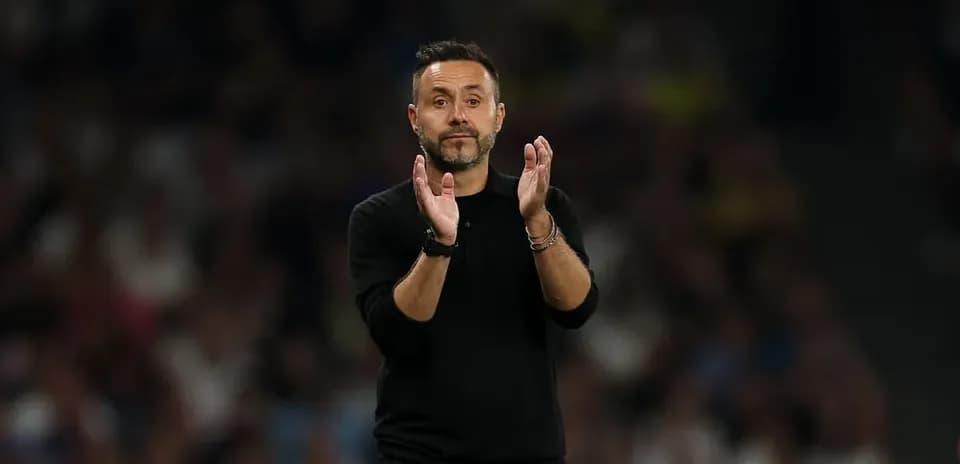 Manager applauding during a match on the sidelines
