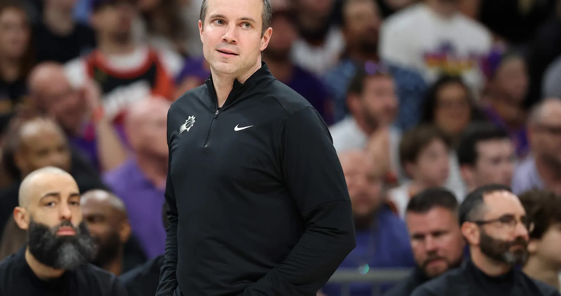 Coach standing on sidelines during basketball game