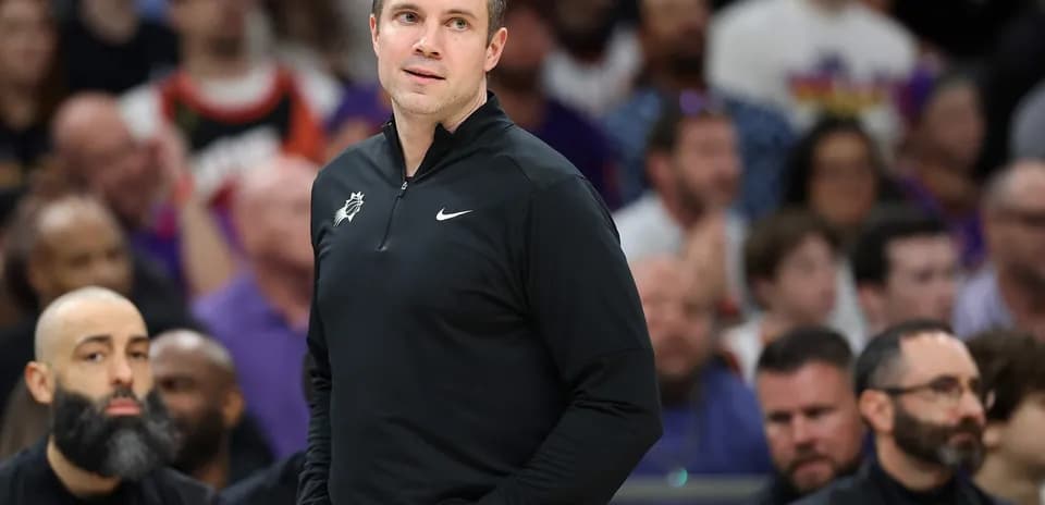 Coach standing on sidelines during basketball game