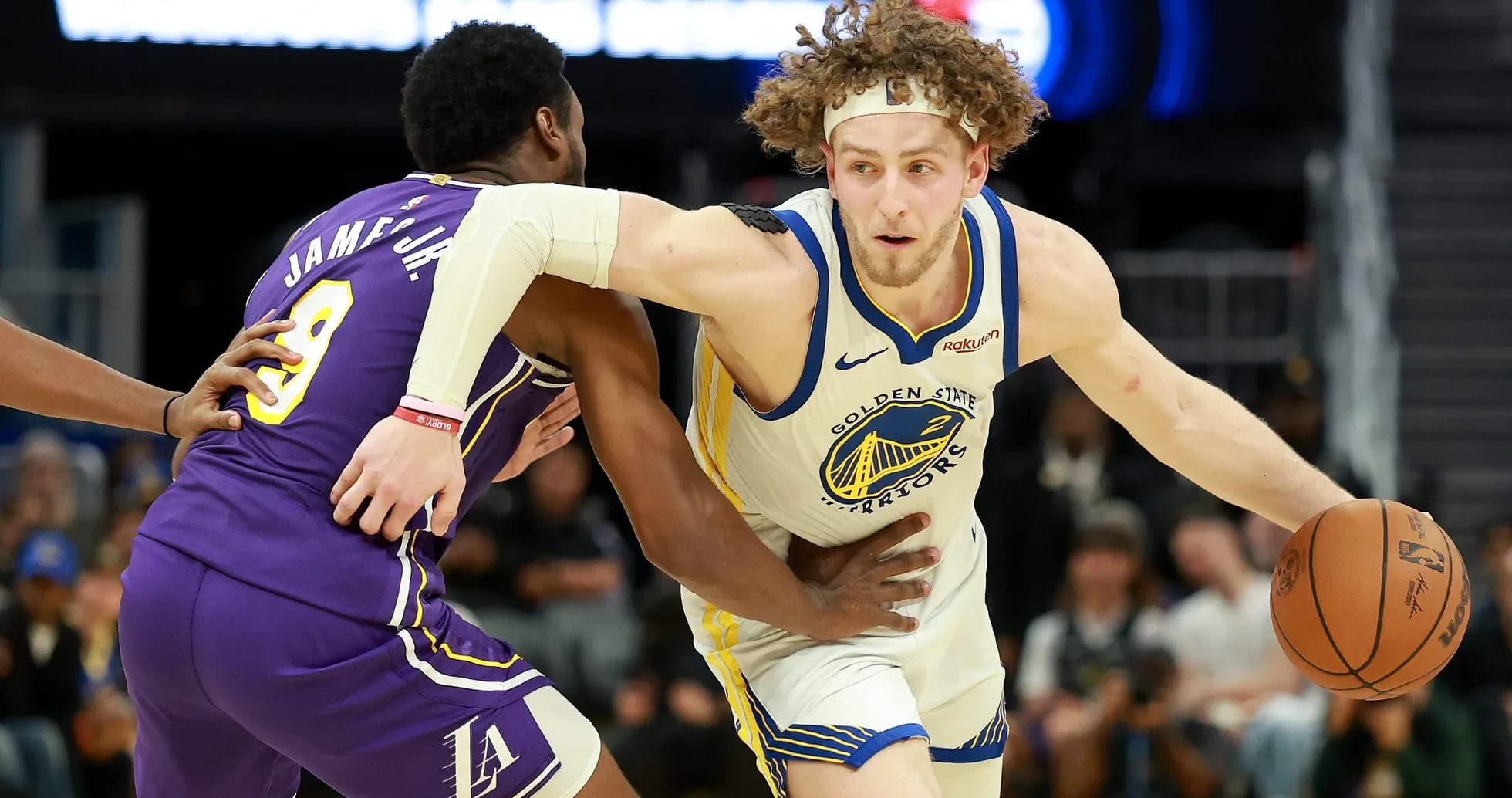 Player from Golden State Warriors dribbling past defender