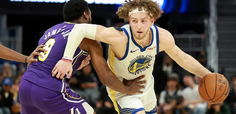 Player from Golden State Warriors dribbling past defender