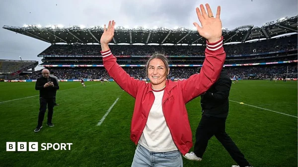 Woman celebrating with arms raised on rugby field Woman celebrating with arms raised on rugby field
