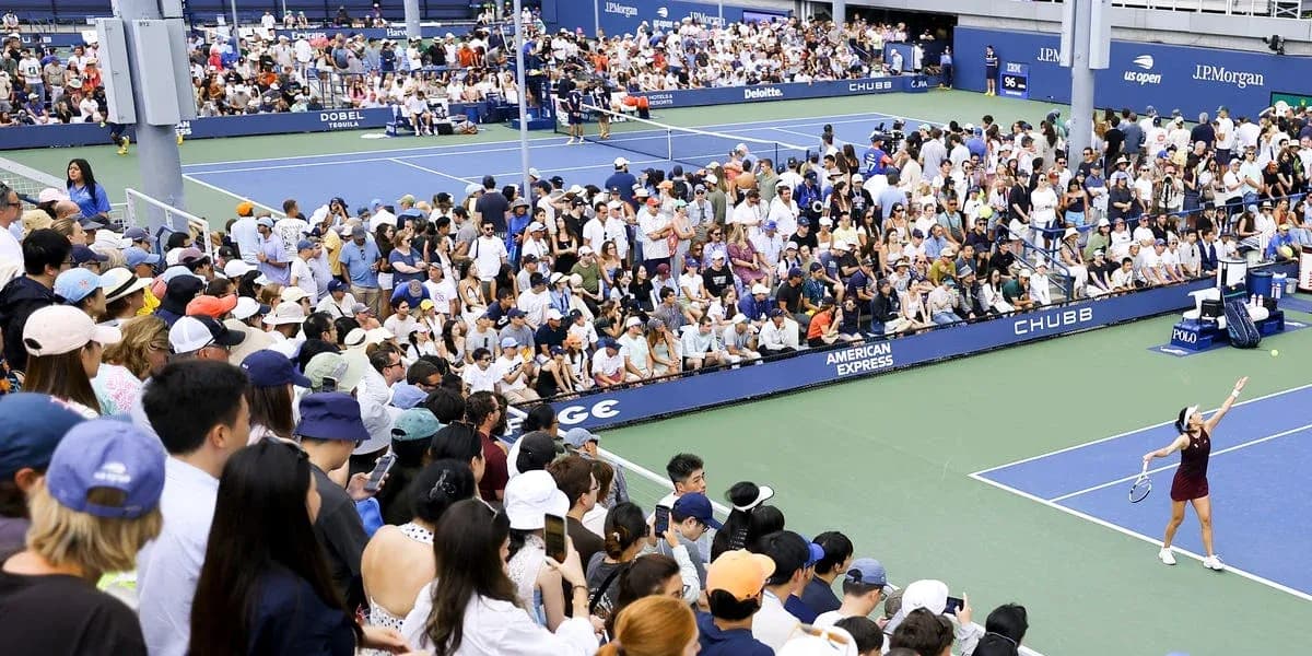 Tennis player serving to crowd at US Open match