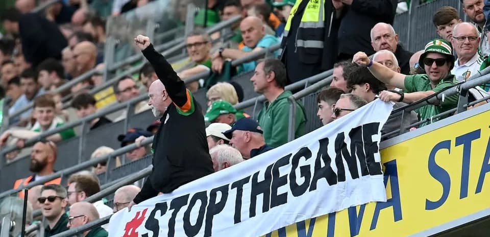 Fans holding a banner during a sporting event
