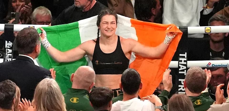 Female boxer celebrating with Irish flag after match
