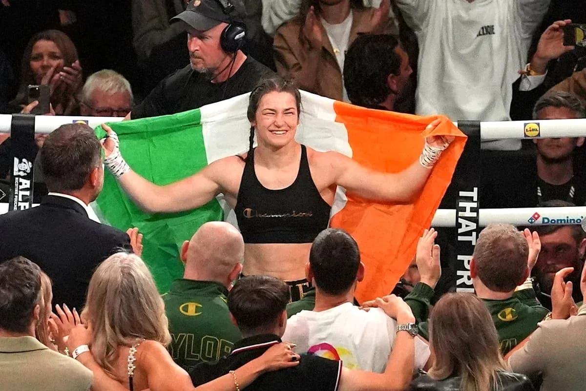 Female boxer celebrating with Irish flag after match