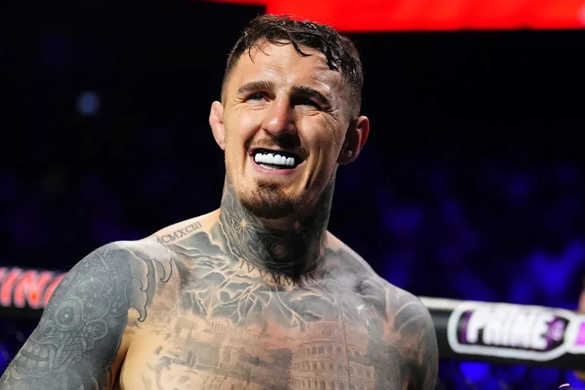 Fighter smiling with tattoos in boxing ring