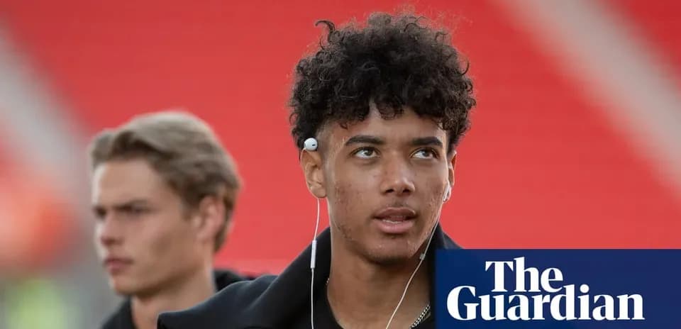 Two young men walking with headphones in stadium