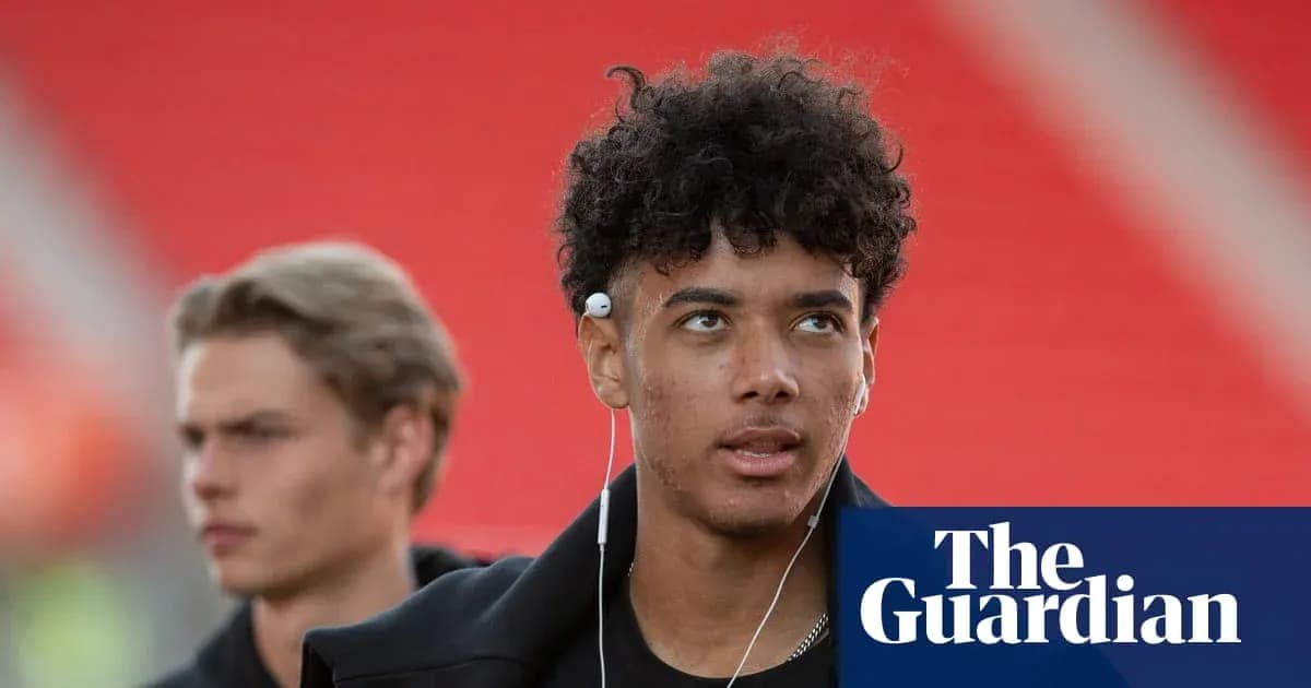 Two young men walking with headphones in stadium