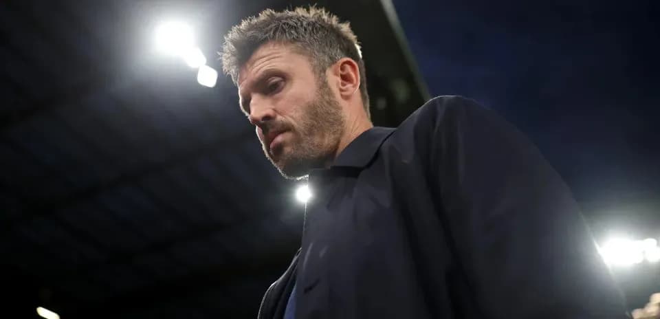 Man looking down at stadium during evening match