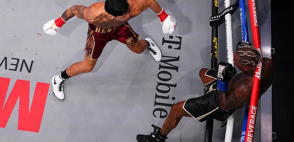 Boxer delivering punch to opponent in ring
