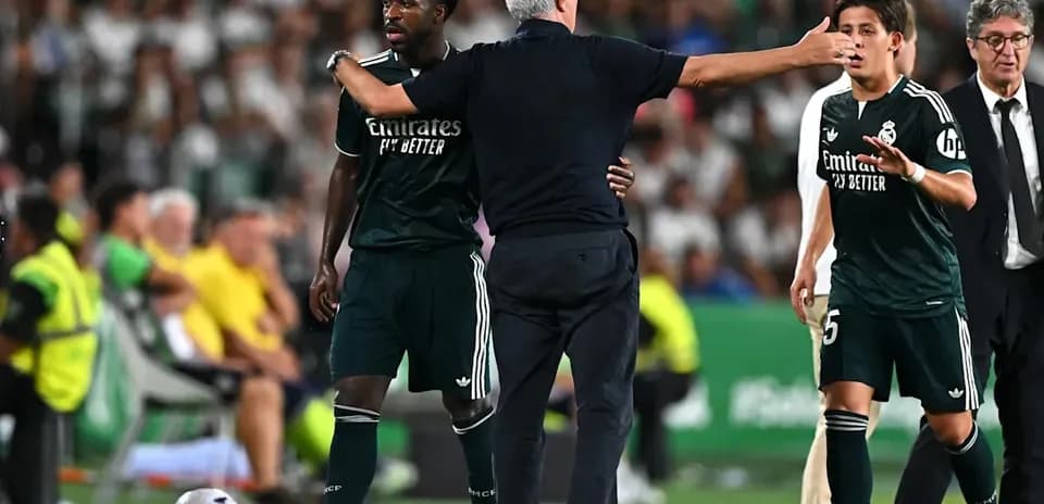 Manager instructing players during match substitution