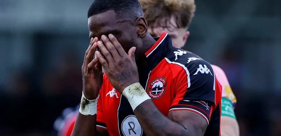 Player holding his face in disappointment on field