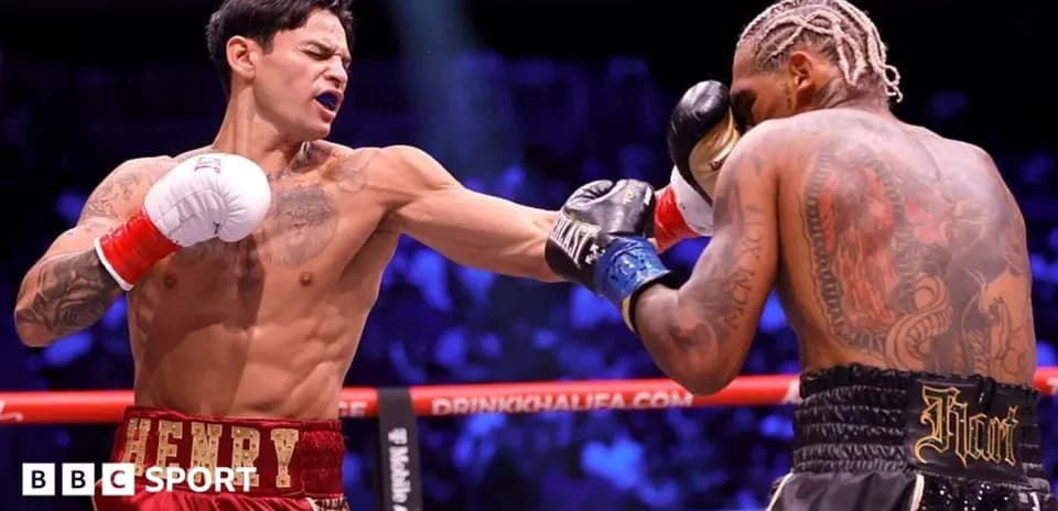 Boxer landing punch on opponent in ring