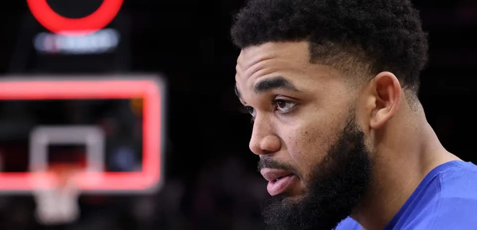 Player on bench with basketball hoop in background