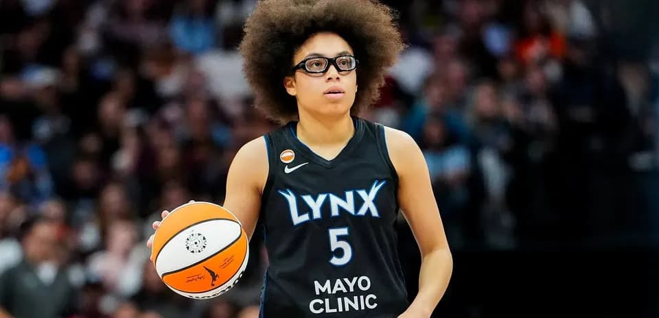 Player in Lynx uniform holding basketball during game