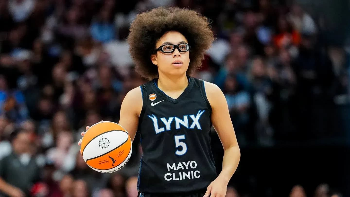 Player in Lynx uniform holding basketball during game