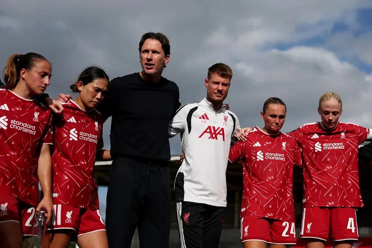 Liverpool Women's team huddling with coaching staff