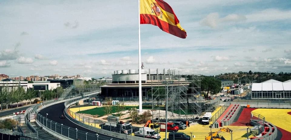 Spanish flag flying over a racing circuit under construction