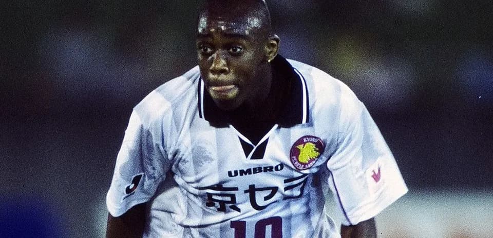 Player in action wearing white football jersey