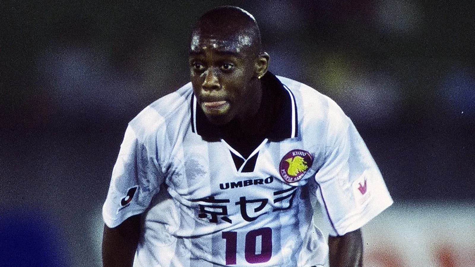 Player in action wearing white football jersey