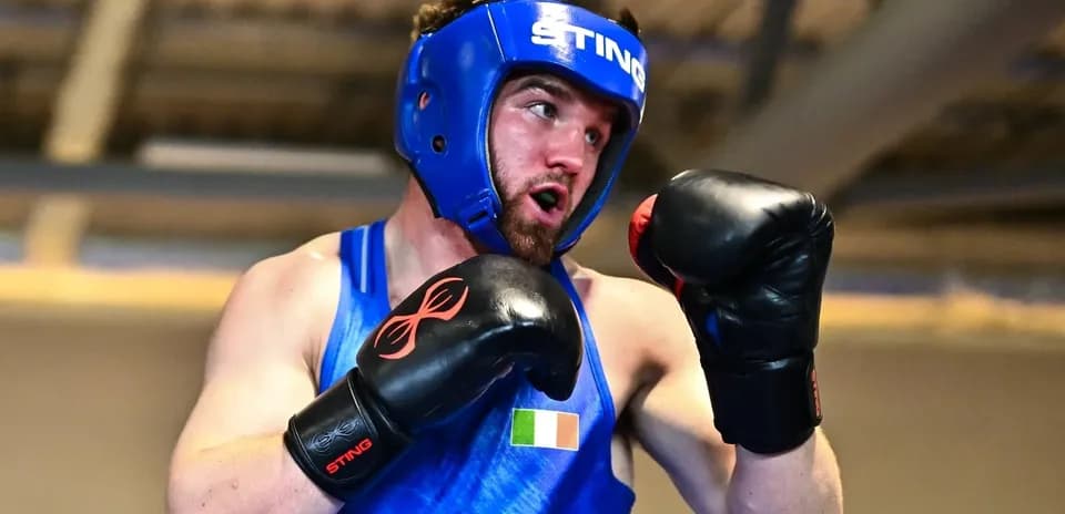 Boxer wearing headgear and gloves during training