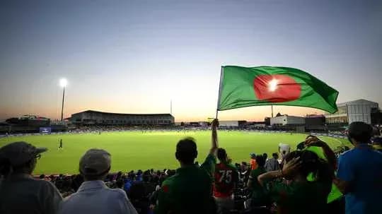 Fans waving Bangladesh flag at cricket match