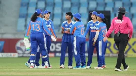 Indian women's cricket team celebrating a wicket on field Indian women's cricket team celebrating a wicket on field