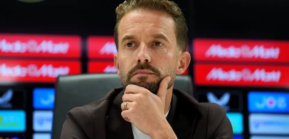 Manager thinking during press conference at podium