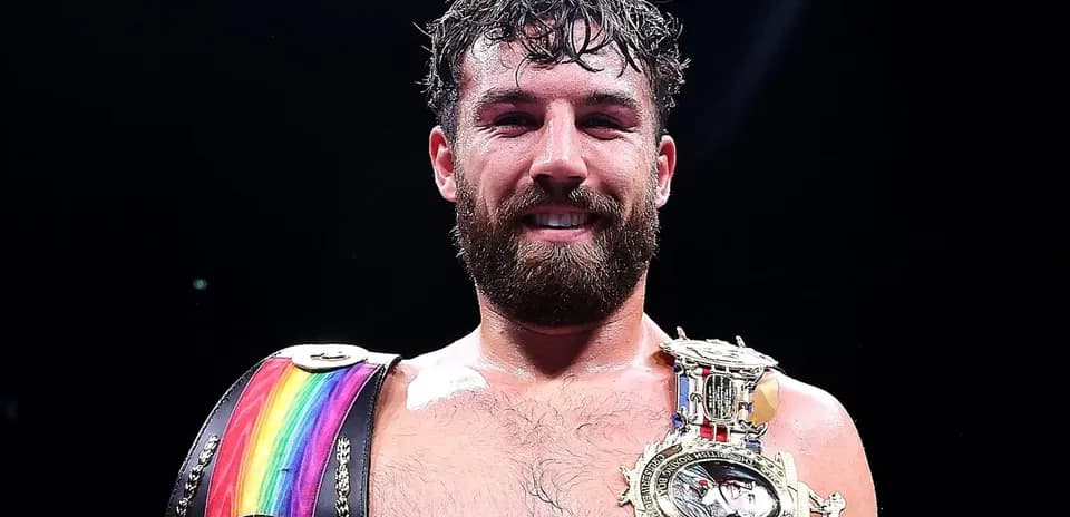 Boxer celebrating with championship belts after match