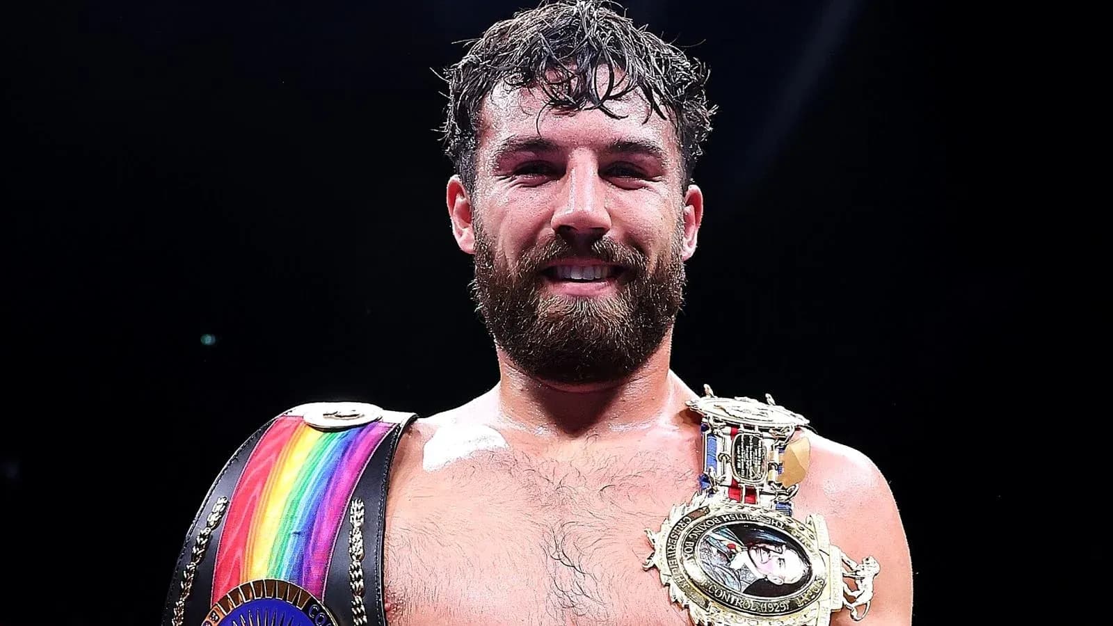 Boxer celebrating with championship belts after match