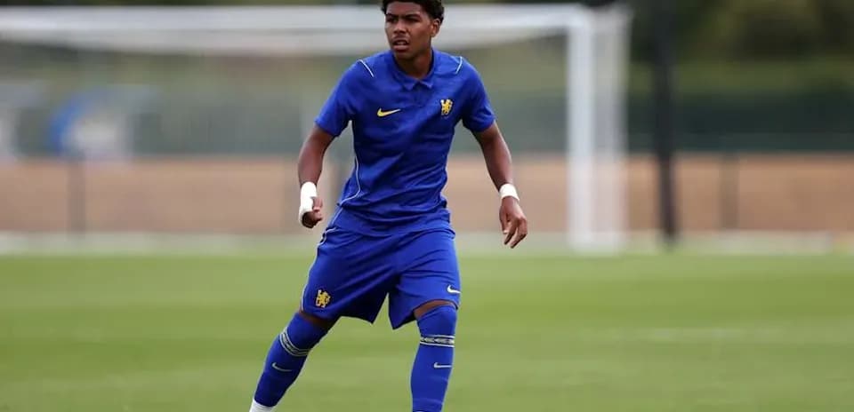 Player training on the pitch in blue kit