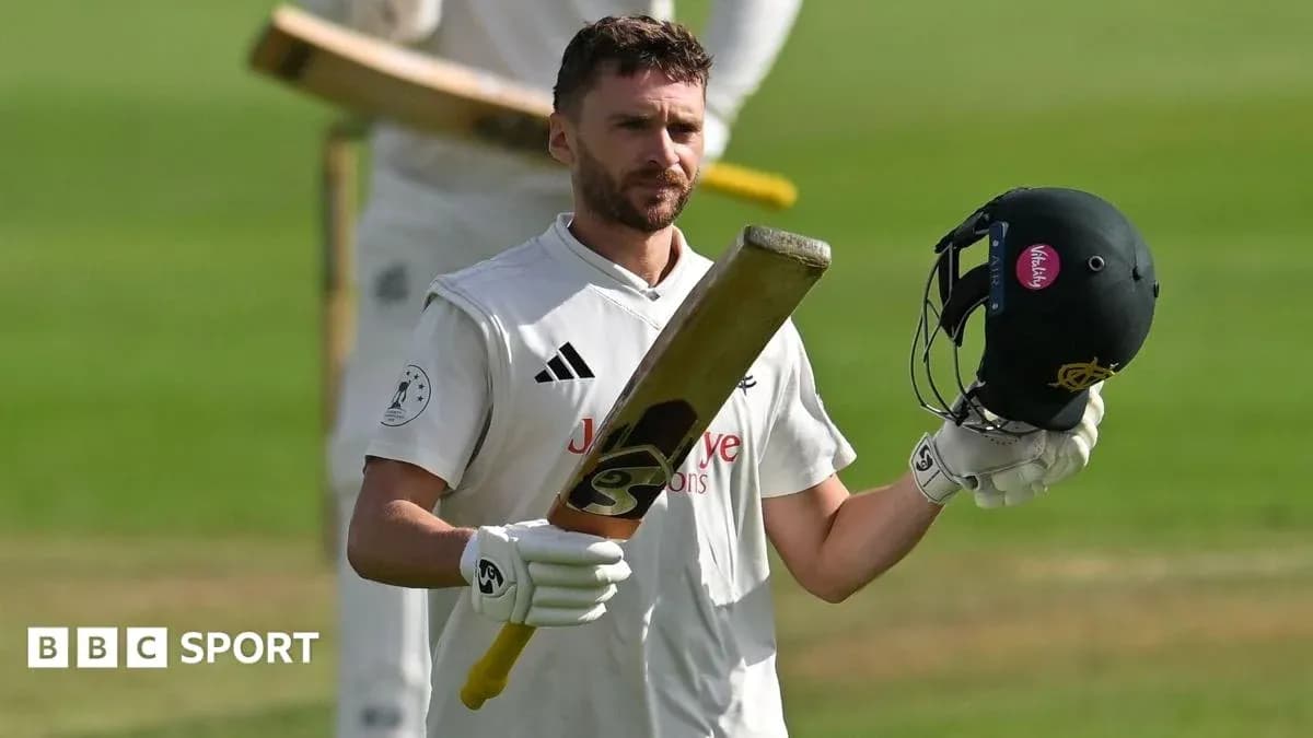 Batsman celebrating with helmet and bat raised