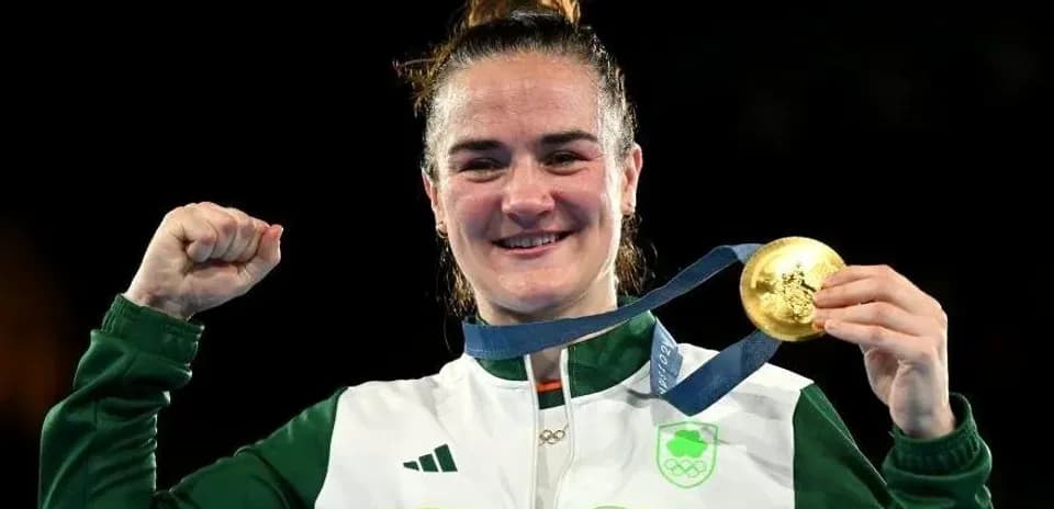 Athlete celebrating with gold medal at event