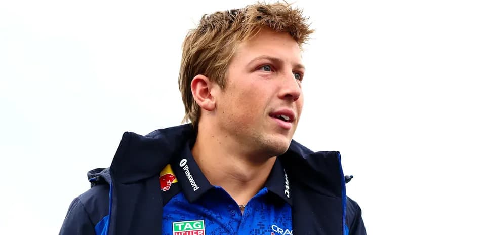 Man in blue racing team jacket looking to the side