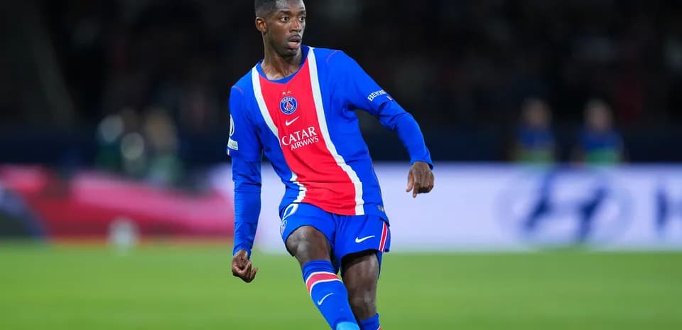 Player in PSG kit dribbling the ball during match