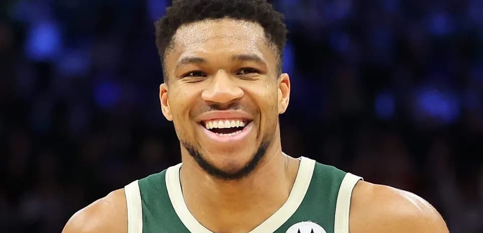 Giannis Antetokounmpo smiling during a game