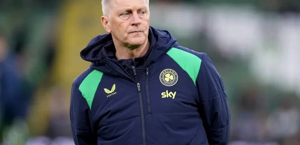 Coach wearing team jacket on the sidelines