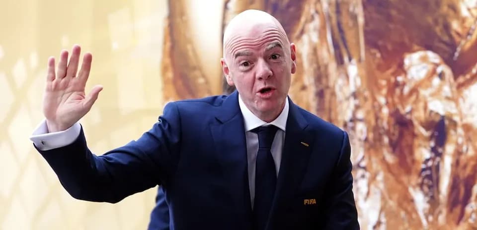 Man in suit gesturing during press event