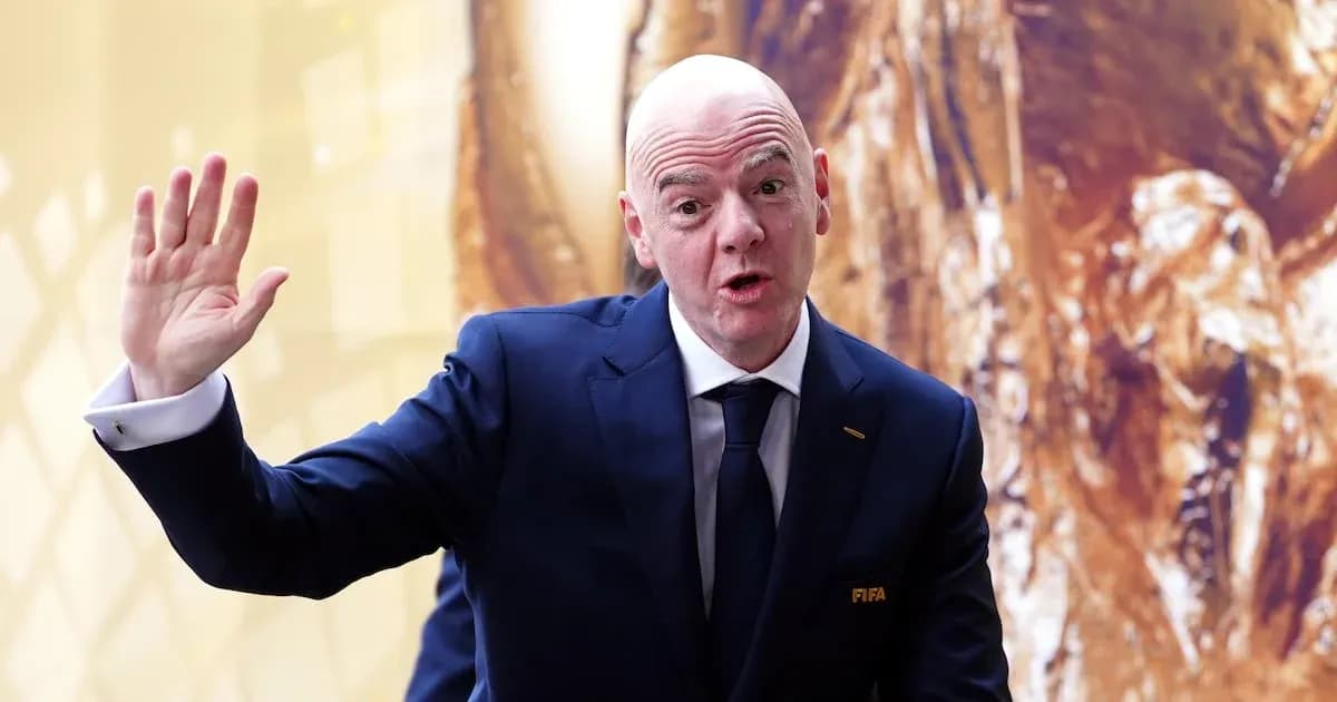 Man in suit gesturing during press event