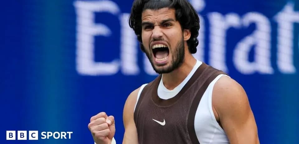 Tennis player celebrating with fist pump on court