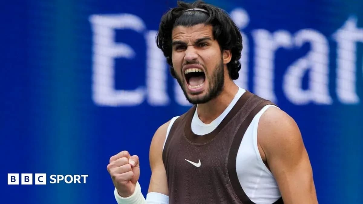 Tennis player celebrating with fist pump on court