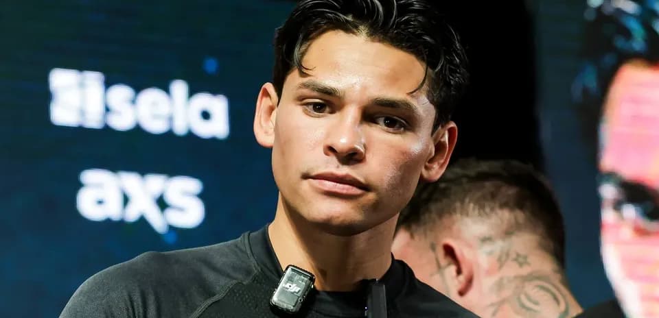 Boxer preparing for event with microphone on shirt