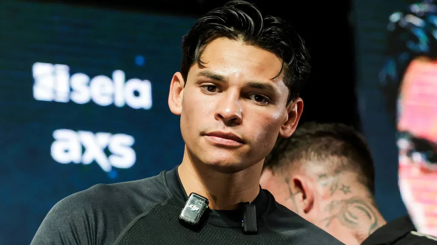 Boxer preparing for event with microphone on shirt