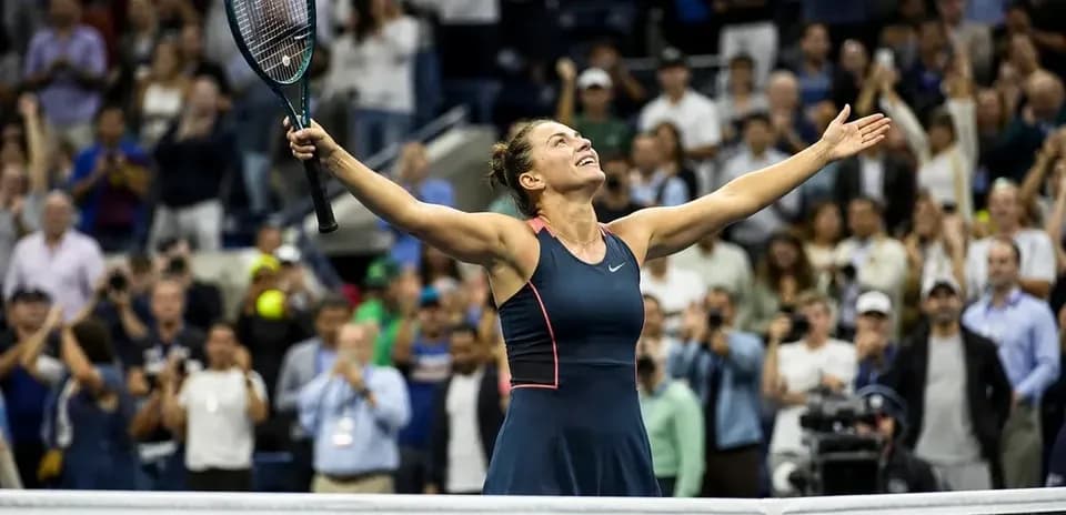 Tennis player celebrating victory with raised arms