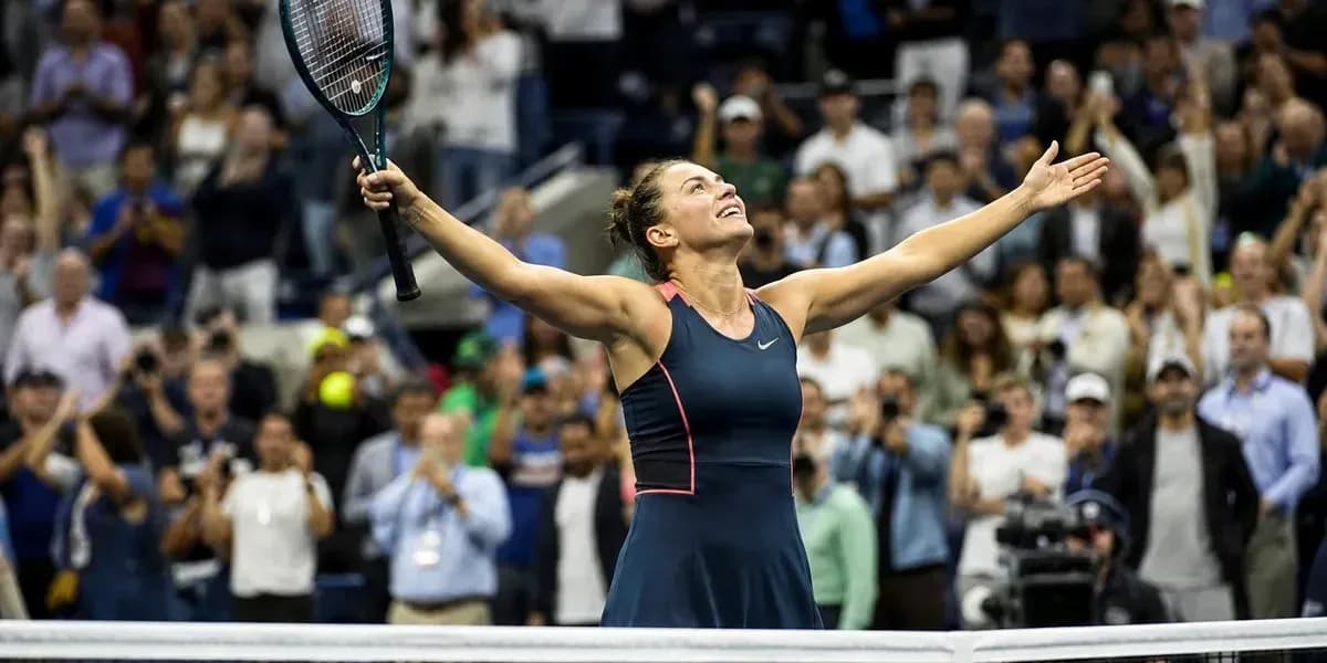 Tennis player celebrating victory with raised arms