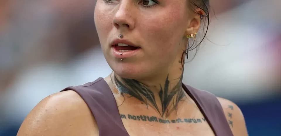 Athlete with tattoos and piercings during match