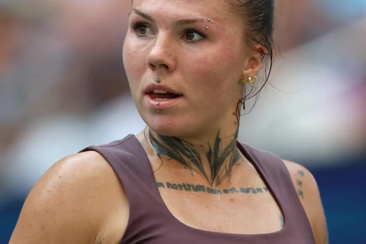Athlete with tattoos and piercings during match