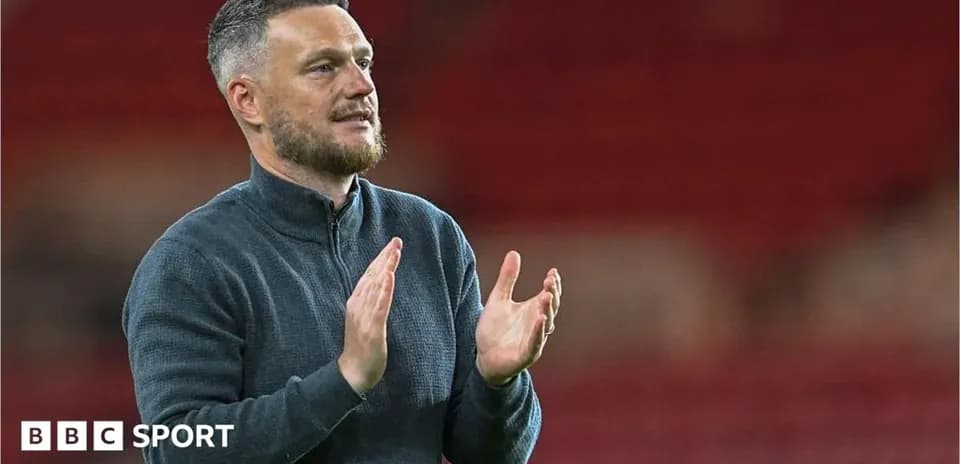 Manager applauding fans after the match