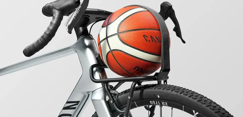 Basketball secured on bicycle rack with handlebars